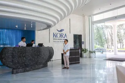 a man standing in the lobby of a kota building at The Sunshine Beach 3-bedrooms Suite with Pool in Layan Beach