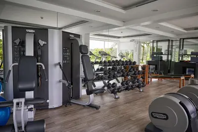 a gym with lots of treadmills and machines at The Nai Harn in Nai Harn Beach