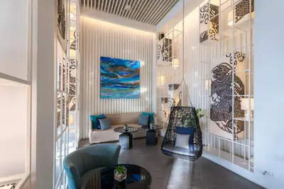 a living room with a couch and a chair at The Nai Harn in Nai Harn Beach