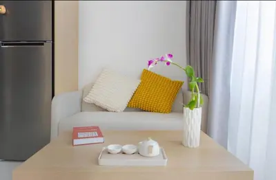a living room with a couch and a table with a vase at Beautiful Sea 1BR apart A6 in Kamala Beach