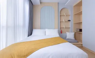 a bedroom with a large white bed with a window at Beautiful Sea 1BR apart A6 in Kamala Beach