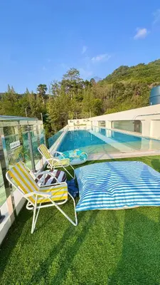 a pair of lawn chairs sitting next to a swimming pool at Beautiful Sea 1BR apart A6 in Kamala Beach