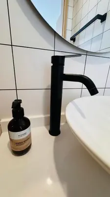 a bottle of soap sitting next to a sink in a bathroom at Beautiful Sea 1BR apart A6 in Kamala Beach