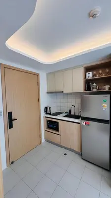 a kitchen with a refrigerator and a sink and a door at Beautiful Sea 1BR apart A6 in Kamala Beach