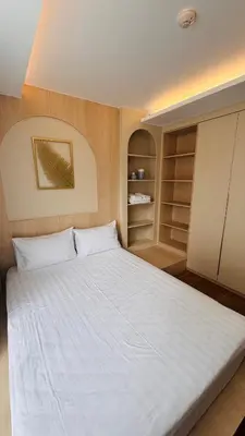 a bedroom with a large white bed and shelves at Beautiful Sea 1BR apart A6 in Kamala Beach