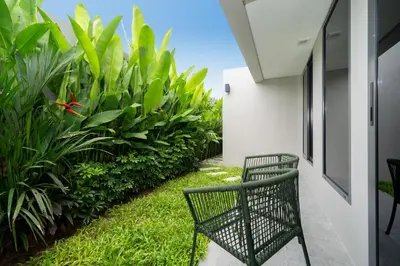 a black chair sitting on the side of a building at Riverhouse Phuket - Private Pool Villas by Escape Villas in Laguna Phuket