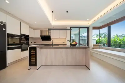 a kitchen with a large island in the middle at Riverhouse Phuket - Private Pool Villas by Escape Villas in Laguna Phuket