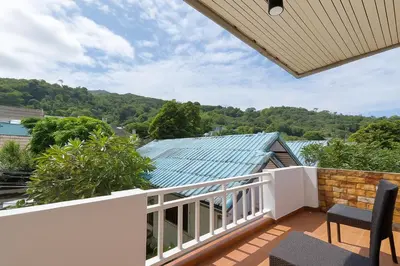 a balcony with a view of a blue roof at Dalbit Thai Stay 2 Bedroom Patong house - 8mins walk to Jungcyelon Bangla Rd in Patong Beach