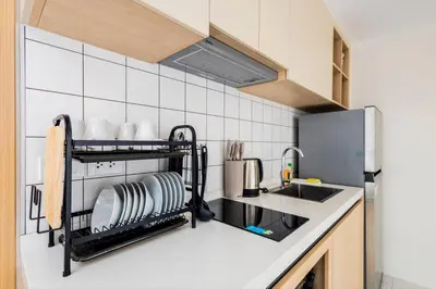 a kitchen with a shelf with dishes on it at Modern 2BR apartment on Kamala Beach in Kamala Beach