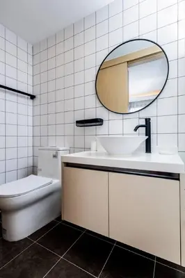 a bathroom with a sink and a mirror and a toilet at Modern 2BR apartment on Kamala Beach in Kamala Beach