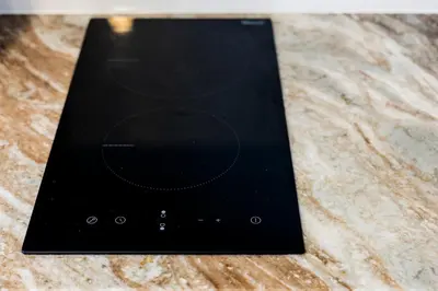 a black cell phone sitting on top of a table at The Signature Suite in Ban Mai Salae