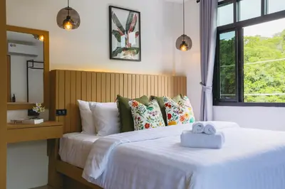 a bedroom with a bed with two towels on it at Wink Hill 4 Penthouse Patong Beach 4Beds in Patong Beach