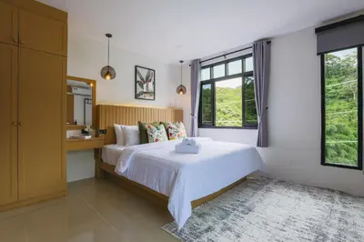 a bedroom with a large bed and a mirror at Wink Hill 4 Penthouse Patong Beach 4Beds in Patong Beach