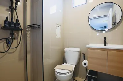 a bathroom with a toilet and a mirror at Wink Hill 4 Penthouse Patong Beach 4Beds in Patong Beach
