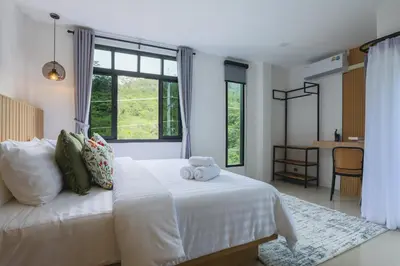 a bedroom with a white bed with a teddy bear on it at Wink Hill 4 Penthouse Patong Beach 4Beds in Patong Beach