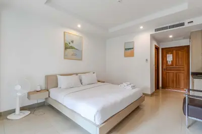 a bedroom with a large white bed in a room at C233 Condo 650m Surin 1BR with Pool &Gym Prime Location in Surin Beach
