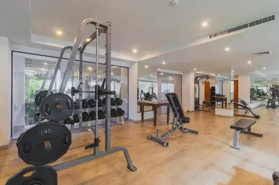 a gym with treadmills and exercise equipment in a house at C233 Condo 650m Surin 1BR with Pool &Gym Prime Location in Surin Beach