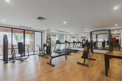 a gym with several treadmills and elliptical machines at C233 Condo 650m Surin 1BR with Pool &Gym Prime Location in Surin Beach