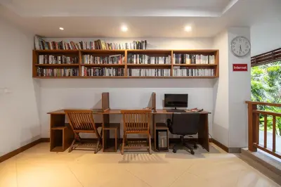 a room with a desk with chairs and a computer at C233 Condo 650m Surin 1BR with Pool &Gym Prime Location in Surin Beach