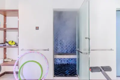 a shower with a glass door and a mirror at V238 Villa 6BR Lakefront Jacuzzi Sauna & Gym, Near Beach in Rawai Beach
