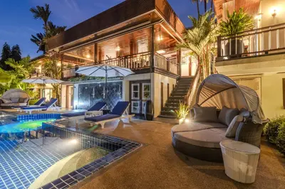 an exterior view of a house with a swimming pool at V238 Villa 6BR Lakefront Jacuzzi Sauna & Gym, Near Beach in Rawai Beach