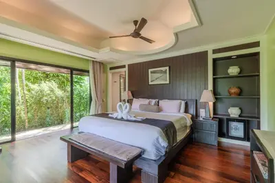 a bedroom with a large bed with a ceiling fan at V238 Villa 6BR Lakefront Jacuzzi Sauna & Gym, Near Beach in Rawai Beach