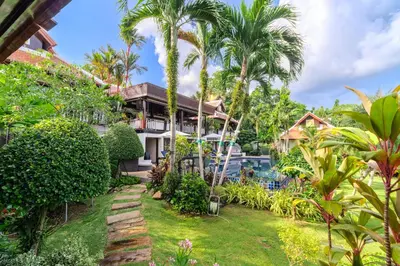 a house with a garden and a swimming pool at V238 Villa 6BR Lakefront Jacuzzi Sauna & Gym, Near Beach in Rawai Beach
