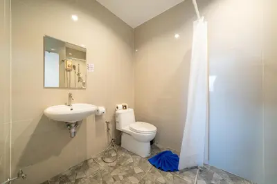 a bathroom with a toilet and a sink and a shower at Rawai Pool House with 3 Bedrooms in Ban Saiyuan (1)