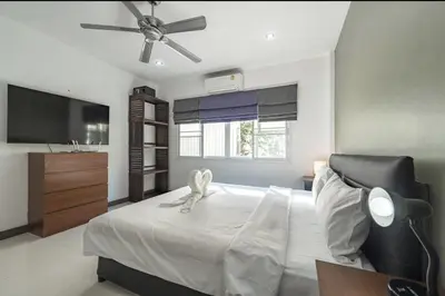 a bedroom with a bed with a ceiling fan at V161 Quiet 4BR with Pool Table, 3 Min to Rawai Beach in Rawai Beach