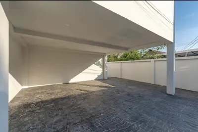 an empty garage with a white roof and a brick floor at V161 Quiet 4BR with Pool Table, 3 Min to Rawai Beach in Rawai Beach