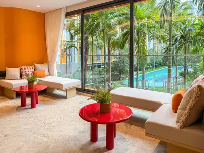 a living room with a large window and a pool at The Base Rise A Cozy Room near Central Phuket Studio Room Pool View in Ban Rangeng