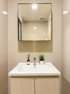 a bathroom with a white sink and a mirror at The Base Rise A Cozy Room near Central Phuket Studio Room Pool View in Ban Rangeng