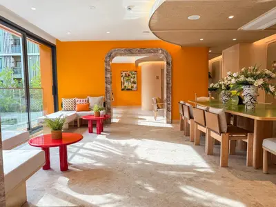 a living room with orange walls and a table and chairs at The Base Rise A Cozy Room near Central Phuket Studio Room Pool View in Ban Rangeng