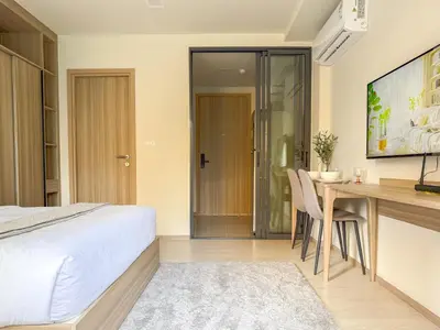 a bedroom with a desk and a bed and a table at The Base Rise A Cozy Room near Central Phuket Studio Room Pool View in Ban Rangeng