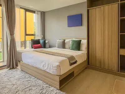 a bedroom with a large bed in a room at The Base Rise A Cozy Room near Central Phuket Studio Room Pool View in Ban Rangeng