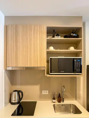 a kitchen with a sink and a microwave at The Base Rise A Cozy Room near Central Phuket Studio Room Pool View in Ban Rangeng