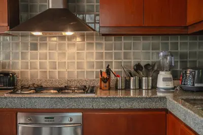 a kitchen counter with a stove and a blender at Surin Ayara Villas by Stayisle in Surin Beach