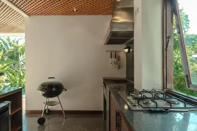 a kitchen with a stove and a grill in it at Surin Ayara Villas by Stayisle in Surin Beach