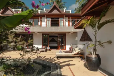 an external view of a house with a patio at Surin Ayara Villas by Stayisle in Surin Beach