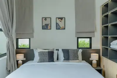 a bedroom with a large white bed and two windows at New 3BR Pool Villa w Jacuzzi Ao Nang Krabi in Ban Khlong Haeng