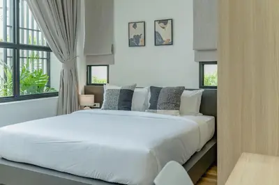 a large white bed in a room with windows at New 3BR Pool Villa w Jacuzzi Ao Nang Krabi in Ban Khlong Haeng