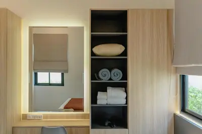 a cabinet with towels and a mirror in a room at New 3BR Pool Villa w Jacuzzi Ao Nang Krabi in Ban Khlong Haeng