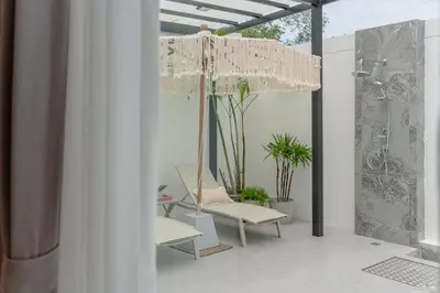 a room with a chair and a chandelier at New 3BR Pool Villa w Jacuzzi Ao Nang Krabi in Ban Khlong Haeng