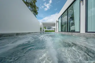 a swimming pool in front of a house at New 3BR Pool Villa w Jacuzzi Ao Nang Krabi in Ban Khlong Haeng