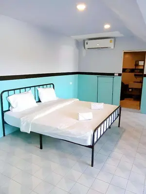 a bed with two pillows on it in a room at Mitr Inn Phuket OldTown - มิตรอินน์ โอลด์ทาวน์ in Phuket Town
