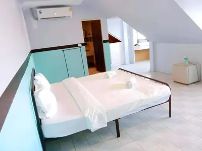 a hospital bed in a room with a staircase at Mitr Inn Phuket OldTown - มิตรอินน์ โอลด์ทาวน์ in Phuket Town