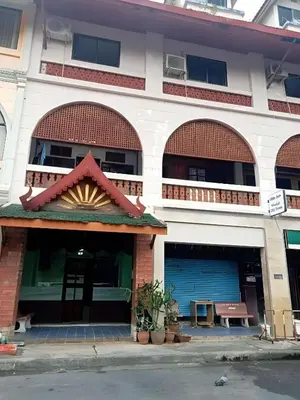 a building with two garage doors and a balcony at Mitr Inn Phuket OldTown - มิตรอินน์ โอลด์ทาวน์ in Phuket Town