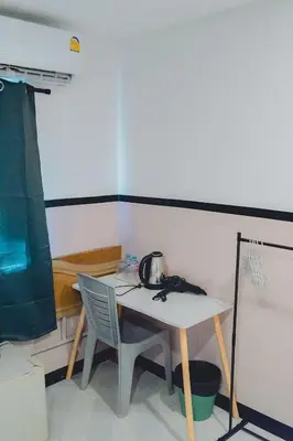 a table and two chairs in a room at Mitr Inn Phuket OldTown - มิตรอินน์ โอลด์ทาวน์ in Phuket Town