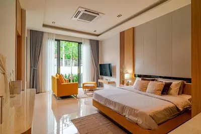 a bedroom with a large bed and a living room at MODERN NEW RELAX VILLA SoL & PooL in Nai Yang Beach