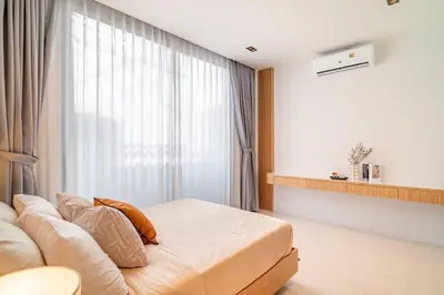 a bedroom with a couch and a large window at MODERN NEW RELAX VILLA SoL & PooL in Nai Yang Beach